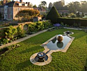 DAVID HARBER SUNDIALS: CHALICE WATER FEATURE AND ETHER WATER FEATURE IN A POOL IN EARLY MORNING DAWN LIGHT. CHAMOMILE LAWN  FORMAL GARDEN