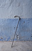 SUITE.DO. A WALKING STICK AGAINST A BLUE WALL IN MALLORCA  SPAIN