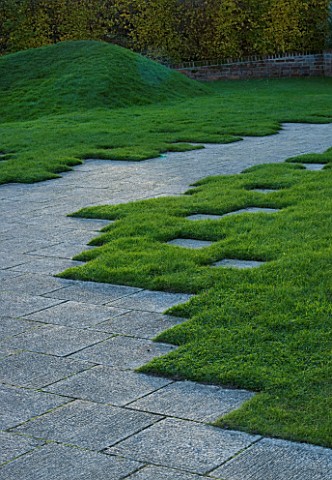MARKS_HALL__ESSEX__A_STONE_PATH_IN_THE_WALLED_GARDEN_WITH_THE_EARTH_SCULPTURE_IN_THE_BACKGROUND