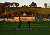 CASTLE HILL  DEVON: VIEW OF THE PALLADIAN HOUSE SEEN ACROSS THE RIVER WITH THE CASTLE BEHIND