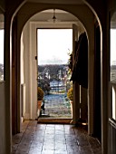 BOONSHILL FARM AT CHRISTMAS: VIEW THROUGH THE HOUSE TO THE FRONT DOOR AND FRONT GARDEN. DESIGNER: LISETTE PLEASANCE