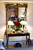 BOONSHILL FARM AT CHRISTMAS: THE LIVING ROOM - BEAUTIFUL TABLE AND MIRROR WITH POINSETTIA. DESIGNER: LISETTE PLEASANCE