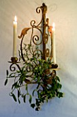 BOONSHILL FARM AT CHRISTMAS: THE DINING ROOM - ORNATE WALL MOUNTED CANDLE HOLDER WITH MISTLETOE. DESIGNER: LISETTE PLEASANCE