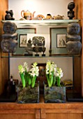 CHARLOTTE ROWES HOUSE - INTERIOR SHOT OF LIVING ROOM WITH DETAIL OF SIDE CABINET WITH WHITE HYACINTHS