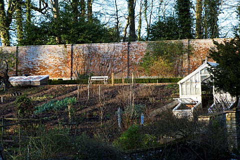 CERNEY_HOUSE__GLOUCESTERSHIRE_THE_OLD_WALLED_GARDEN_WITH_CLOCHE_AND_GREENHOUSE