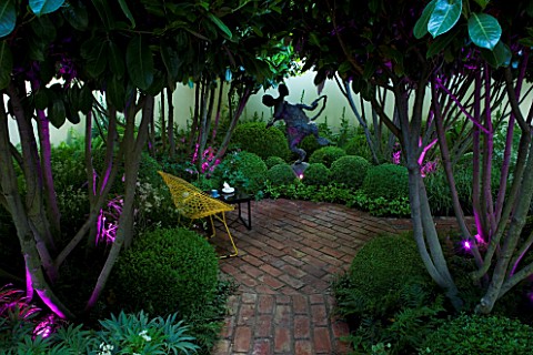 CHELSEA_2008__DESIGNER_DIARMUID_GAVIN_LOLLIPOP_CATALPA_TREES__BRICK_PATH_AND_TABLE_AND_CHAIRS_LIT_UP