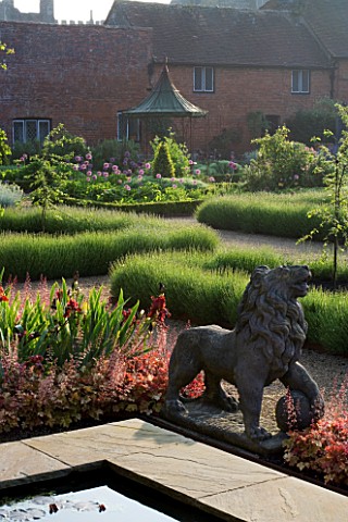 THE_WALLED_GARDEN_AT_COWDRAY__WEST_SUSSEX_DESIGNER_JAN_HOWARD__LION_STATUE__RAISED_PONDPOOL_WITH_HEU