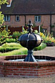 THE WALLED GARDEN AT COWDRAY  WEST SUSSEX. DESIGNER: JAN HOWARD - RAISED BRICK POOL/POND WITH METAL BOAR HEAD FOUNTAIN