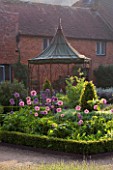 THE WALLED GARDEN AT COWDRAY  WEST SUSSEX. DESIGNER: JAN HOWARD - METAL GAZEBO WITH BOX EDGED BEDS WITH ALLIUM PURPLE SENSATION