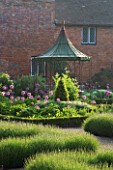 THE WALLED GARDEN AT COWDRAY  WEST SUSSEX. DESIGNER: JAN HOWARD - METAL GAZEBO AND BOX EDGED BEDS WITH ALLIUM PURPLE SENSATION. IN THE FOREGROUND IS LAVENDER