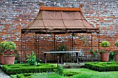 THE WALLED GARDEN AT COWDRAY  WEST SUSSEX. DESIGNER: JAN HOWARD - METAL GAZEBO AND PARTERRE OF LOW LEVEL BOX EDGED BEDS