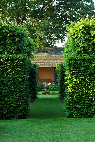 WOLLERTON_OLD_HALL__SHROPSHIRE_VIEW_THROUGH_HEDGES_TO_SUNDIAL_AND_SUMMERHOUSE_VISTA