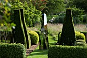 DAVID HARBER SUNDIALS: STAINLESS STEEL MIRRORED OBELISK SUNDIAL ON GRASS PATH WITH YEW TOPIARY IN FORMAL SETTING AT PETTIFERS GARDEN  OXFORDSHIRE