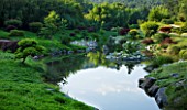 LA BAMBOUSERAIE DE PRAFRANCE  FRANCE: THE JAPANESE GARDEN - THE DRAGON VALLEY DESIGNED BY ERIK BORJA - THE LAKE WITH ROCKS AND CLOUD PRUNED CONIFERS
