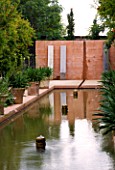 LA NORIA  FRANCE. GARDEN DESIGNED BY ARNAUD MAURIERES AND ERIC OSSART - WATER GARDEN - ISLAMIC STYLE GARDEN WITH RILL AND CONCRETE WALL AND SEATS