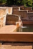 LA NORIA  FRANCE. GARDEN DESIGNED BY ARNAUD MAURIERES AND ERIC OSSART - WATER GARDEN - ISLAMIC STYLE STONE WATER SPOUT AND POOL