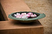 LA NORIA  FRANCE. GARDEN DESIGNED BY ARNAUD MAURIERES AND ERIC OSSART - STONE BOWL WITH FLOATING FLOWERS