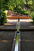 LA NORIA  FRANCE. GARDEN DESIGNED BY ARNAUD MAURIERES AND ERIC OSSART - THE ALLEE DES CYPRES - THE ISLAMIC STYLE WATER GARDEN - RILL LEADING TO WATER BASIN AND STONE FOUNTAIN