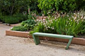 LA NORIA  FRANCE. GARDEN DESIGNED BY ARNAUD MAURIERES AND ERIC OSSART - GREEN CONCRETE BENCH AND BORDER OF GAURA