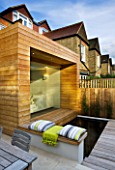 GARDEN DESIGNER: CHARLOTTE ROWE  LONDON: GLASS & TIMBER EXTENSION AND DECK/POOL WITH THROW AND CUSHIONS