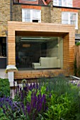 GARDEN DESIGNER: CHARLOTTE ROWE  LONDON: VIEW TOWARDS HOUSE WITH GLASS & TIMBER EXTENSION FROM FORMAL TOWN/CITY GARDEN WITH PERENNIAL PLANTING
