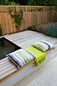 DESIGNER: CHARLOTTE ROWE  LONDON: FORMAL TOWN/CITY GARDEN WITH SPLIT-LEVEL DECK  FENCE/TRELLIS  POOL AND CUSHIONS/ THROW