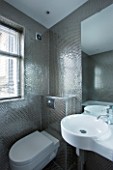 TANIA LAURIE  LONDON. STYLISH  CONTEMPORARY BATHROOM WITH WHITE SUITE AND SILVER HONEYCOMB EFFECT  MOSAIC TILES