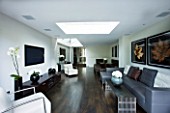 TANIA LAURIE  LONDON. INTERIOR OF LIVING / DINING AREA WITH ROOFLIGHT  WOODEN FLOOR AND CONTEMPORARY FURNITURE