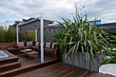 CONTEMPORARY FORMAL ROOF TERRACE/ GARDEN DEIGNED BY DATA NATURE ASSOCIATES: DECK AREA WITH PERGOLA  TABLE AND SEATING. RAISED MEATL BED WITH PHORMIUM