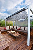 CONTEMPORARY FORMAL ROOF TERRACE/ GARDEN DESIGNED BY DATA NATURE ASSOCIATES: DECK AREA WITH PERGOLA  TABLE AND SEATING.METAL BEAD ROOF