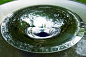 DAVID HARBER SUNDIALS: CLOSE UP OF SWIRLING WATER AT THE CENTRE OF VORTEX WATER FEATURE