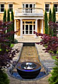 DAVID HARBER. WATER FEATURE: CHALICE WITH WATERFALL  RILL AND HOUSE IN BACKGROUND