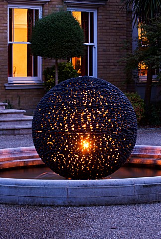 DAVID_HARBER_WATER_FEATURE_CLOSE_UP_OF_DARK_PLANET_GARDEN_SPHERE_LIT_UP_AT_NIGHT