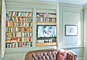 ARCHITECT CHRIS DYSONS HOUSE: THE LIVING ROOM WITH DOORS OPEN SHOWING BOOKS AND TELEVISION