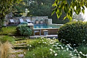 PROVENCE  FRANCE: GARDEN OF NICOLE DE VESIAN  LA LOUVE: SWIMMING POOL AT DAWN ON THE LOWER ETRRACE WITH COUNTRYSIDE BEYOND