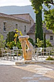 PROVENCE  FRANCE: DOMAINE DE LA VERRIERE: A PLACE TO SIT- WOODEN SCULPTURE BY MARC NUCERA NEAR SEATING AREA