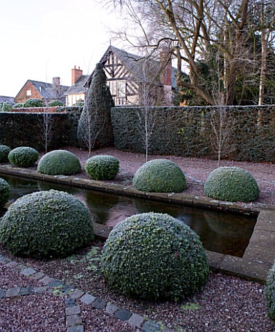 WOLLERTON_OLD_HALL__SHROPSHIRE_WINTER_GARDEN_IN_FROST___THE_RILL_GARDEN___A_WIDE_CANAL_LINED_WITH_BO