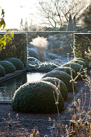 WOLLERTON_OLD_HALL__SHROPSHIRE_WINTER_GARDEN_IN_FROST___THE_RILL_GARDEN_WITH_CANAL_LINED_WITH_BOX_BA