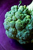 ORGANIC BROCCOLI ON PURPLE BACKGROUND. VEGETABLE  HEALTHY EATING  HEALTHY LIVING  GREEN