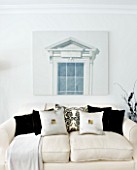 CHRISTMAS - LIVING ROOM WITH CREAM SOFAS  CUSHIONS AND WALL PRINT. SARAH EASTEL LOCATIONS/ DI ABLEWHITE