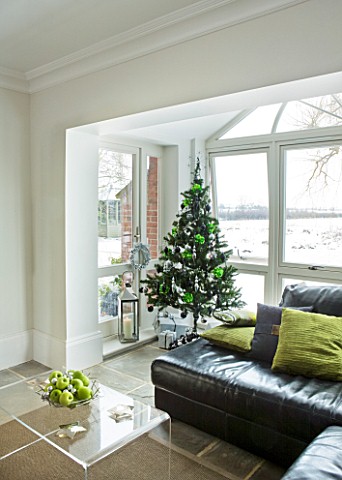 CHRISTMAS__LOUNGE_IN_LIME_GREEN_AND_BLACK__BLACK_LEATHER_SOFAS__LIME_GREEN_CUSHIONS__CHRISTMAS_TREE_