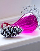 CLARE MATTHEWS CHRISTMAS HOUSE INTERIOR: WINDOWSILL WITH PINK GLASS DECORATION AND SPRAYED FIR CONE