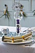CLARE MATTHEWS CHRISTMAS HOUSE INTERIOR: KITCHEN TABLE WITH PLATE  CRACKER  SILVER CANDLES ON MIRROR  GLASS WITH BAUBLES AND DRIED ALLIUMS