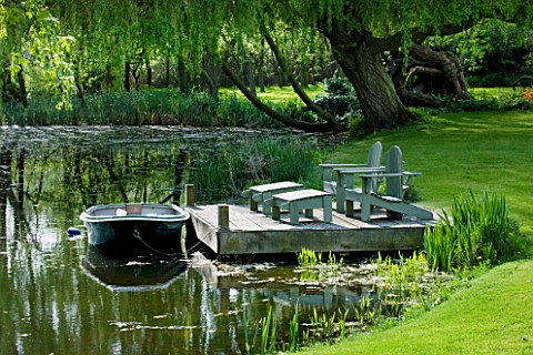 ULTING_WICK__ESSEX_SPRING__A_PLACE_TO_SIT__DECKED_TERRACE_BESIDE_THE_LAKE_WITH_ADIRONDACK_WOODEN_CHA
