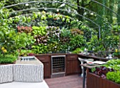 CHELSEA FLOWER SHOW 2009:  FRESHLY PREPPED GARDEN BY ARALIA. OUTDOOR KITCHEN/ENTERTAINING AREA WITH EDIBLE LIVING WALL PLANTED WITH BABY SALAD LEAVES
