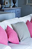 DESIGNER: CLAIRE SKINNER  ROU ESTATE  CORFU: HOUSE INTERIOR - LIVING ROOM IN GREY  CREAM AND PINK. CREAM SOFA WITH GREY AND PINK CUSHIONS