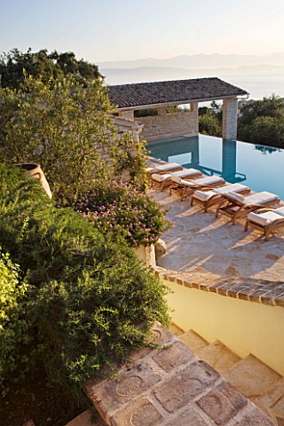 PRIVATE_VILLA__CORFU__GREECE_DESIGN_BY_ALITHEA_JOHNS__VIEW_DOWN_TO_SWIMMING_POOL_AND_MOUNTAINS_OF_AL