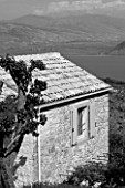 THE ROU ESTATE  CORFU: BLACK AND WHITE IMAGE OF HOUSE WITH ALBANIA IN BACKGROUND