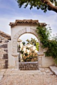 THE ROU ESTATE  CORFU: STONE ARCH WITH FIG TREE BEHIND