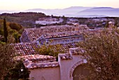 THE ROU ESTATE  CORFU: VIEW ACROSS TILED ROOFS AT DAWN WITH ALBANIAN MOUNTAINS BEYOND